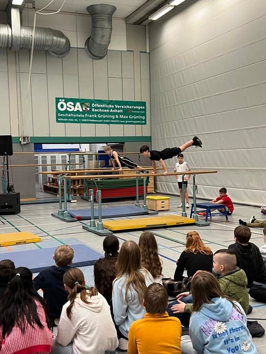 Zwei Schüler turnen an zwei Barren